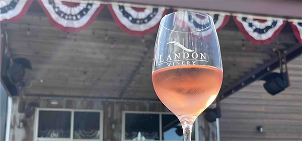 Photo of a glass of wine outside of a local building