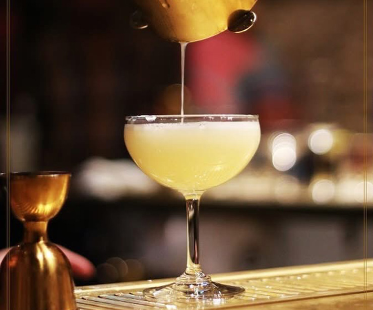 dining-header-img-desktop Photo of a margarita being poured at a bar.